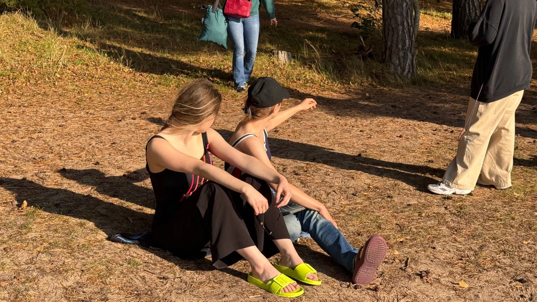 Two Film Camp participants sitting on the ground during an outdoor shoot