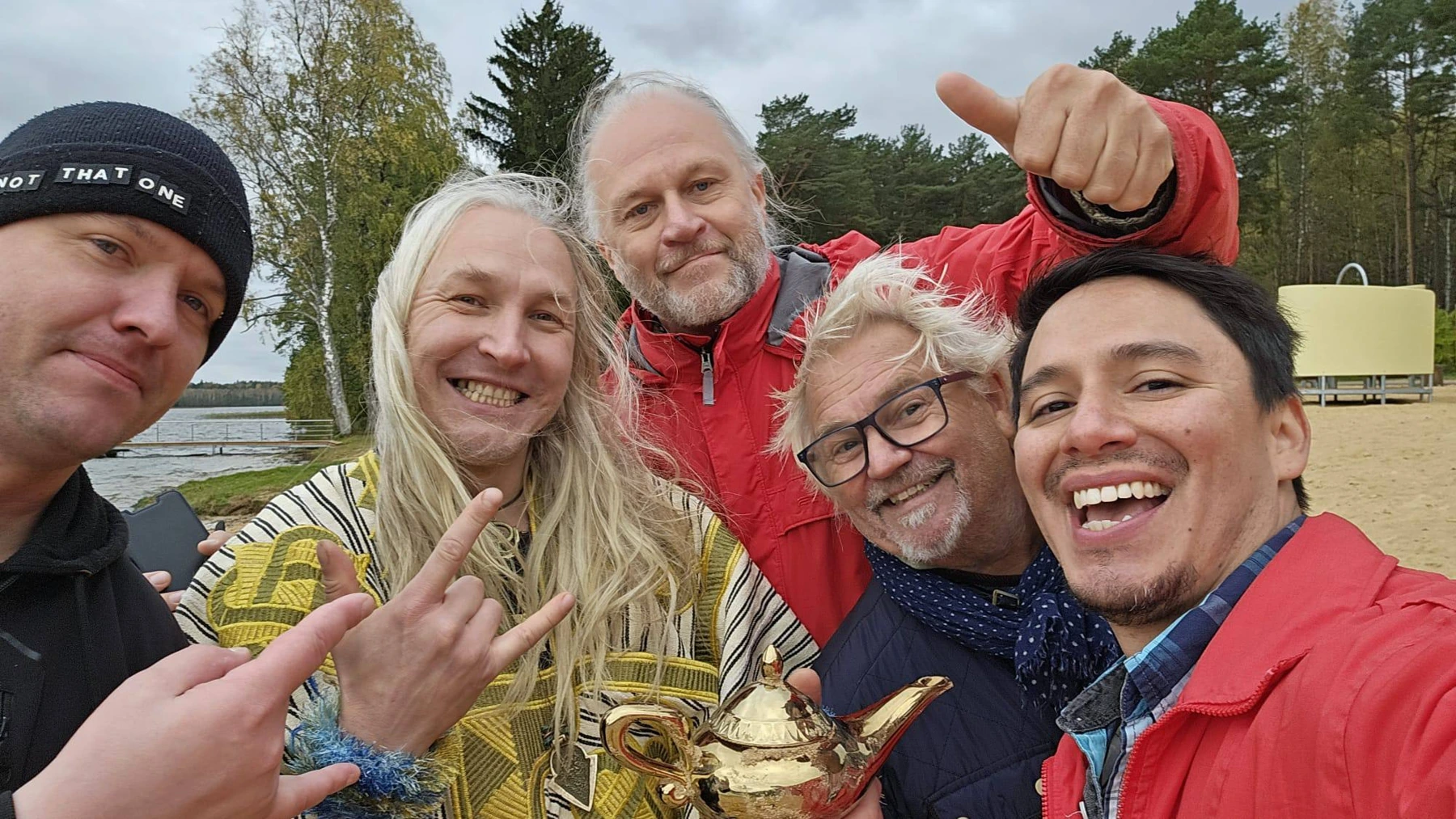 Film Camp group taking a cheerful selfie by the lake with a golden teapot