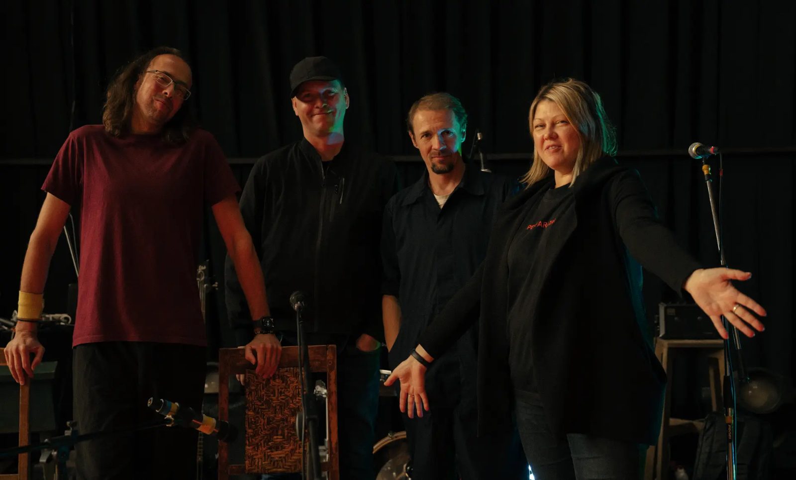 Group of musicians on stage after a rehearsal