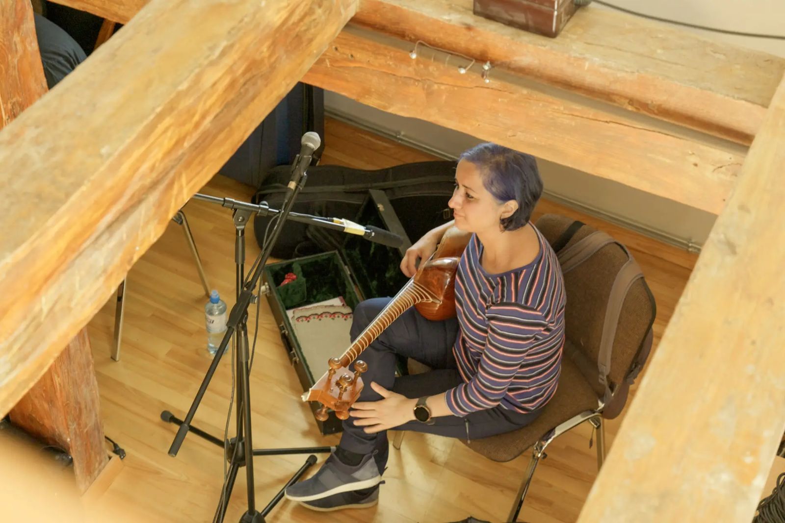 Musician playing tar during a rehearsal