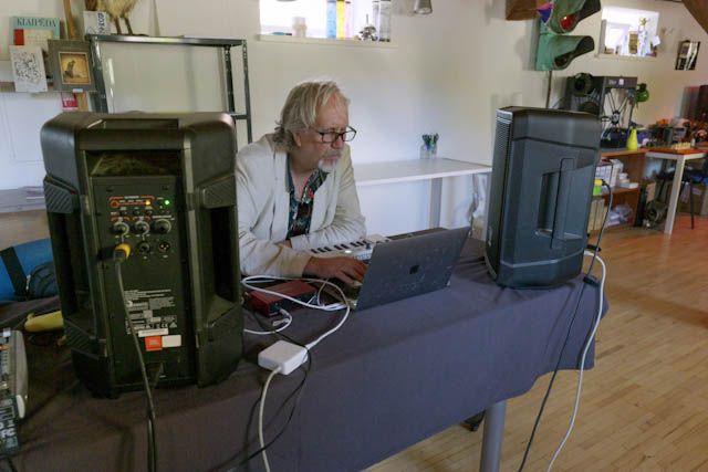 Composer working on a laptop during the camp